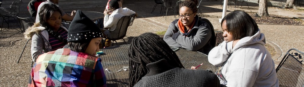 Students sitting around table talking